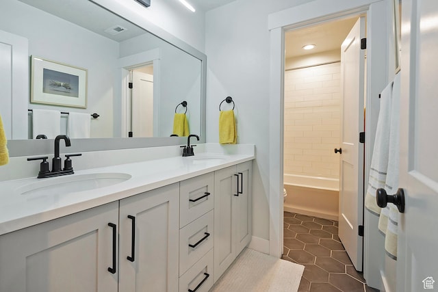 bathroom with tile patterned flooring, a sink, recessed lighting, and double vanity