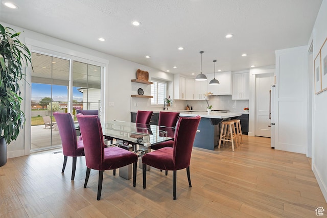 dining space with recessed lighting, light wood-style floors, and baseboards