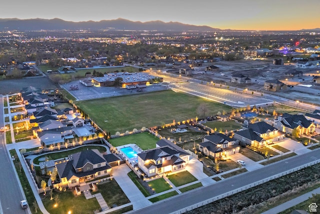 aerial view at dusk featuring a mountain view