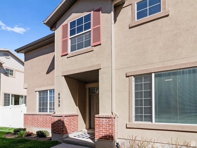 6939 S Tourist Ln W Unit 2C, West Jordan, UT 84084 - exterior space with stucco siding, fence, and brick siding