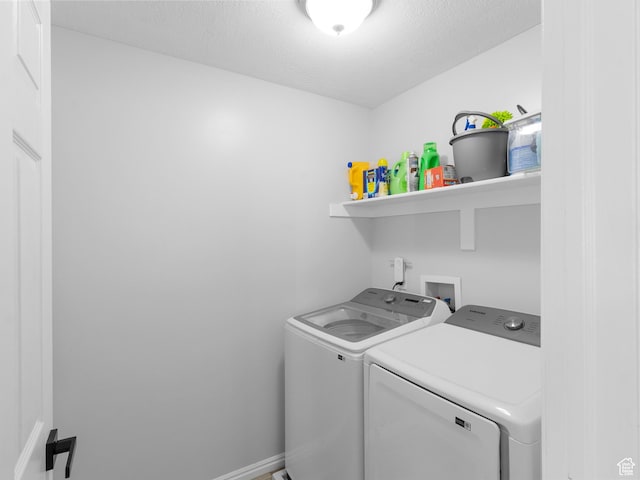 6939 S Tourist Ln W Unit 2C, West Jordan, UT 84084 - laundry area featuring washing machine and dryer, baseboards, a textured ceiling, and laundry area
