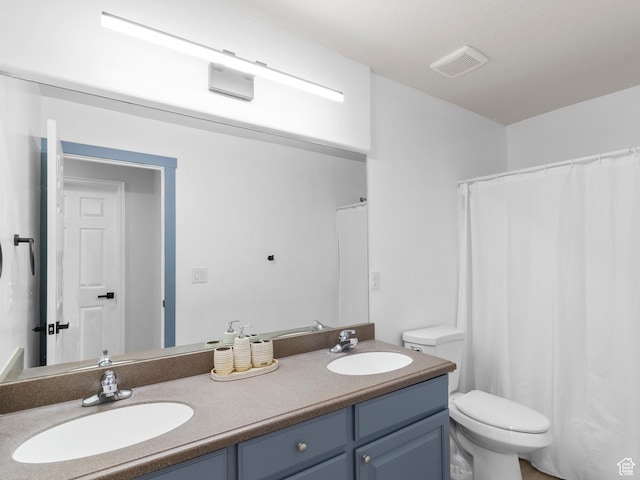 6939 S Tourist Ln W Unit 2C, West Jordan, UT 84084 - bathroom with toilet, a sink, visible vents, and double vanity