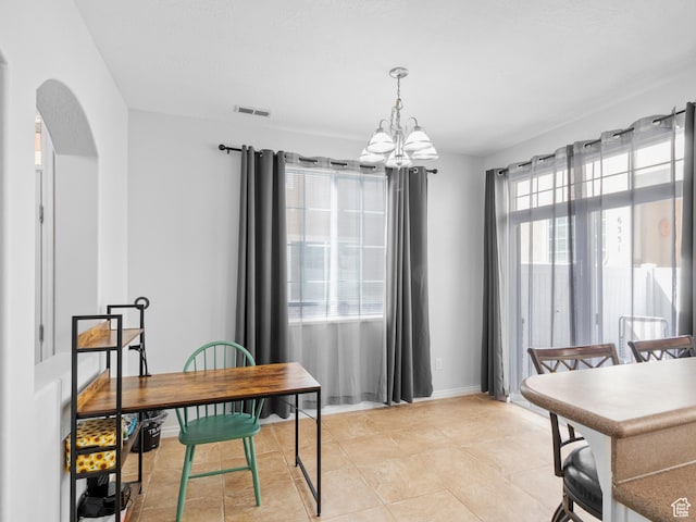 6939 S Tourist Ln W Unit 2C, West Jordan, UT 84084 - dining area with light tile patterned floors, arched walkways, baseboards, a notable chandelier, and visible vents