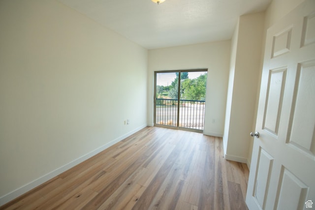 unfurnished room featuring light wood-style floors and baseboards