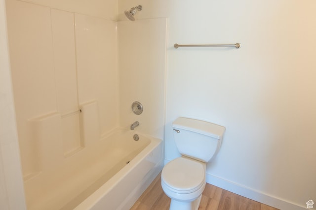 full bath featuring shower / bathtub combination, baseboards, toilet, and wood finished floors
