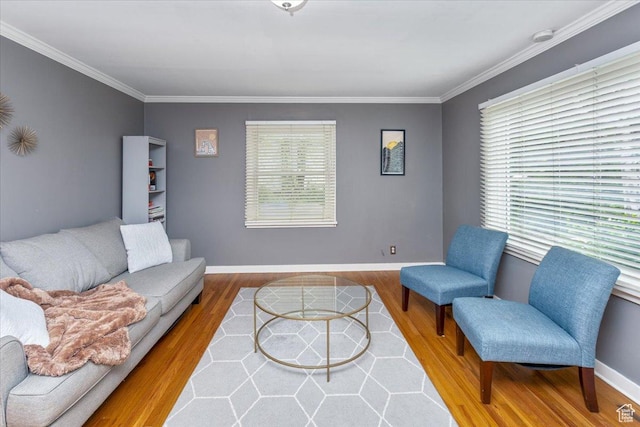 living area featuring wood finished floors, baseboards, and ornamental molding