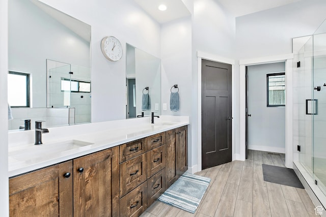 1678 S Ridgeline Dr Unit 1276, Heber City, UT 84032 - bathroom featuring double vanity, a shower stall, a healthy amount of sunlight, and a sink