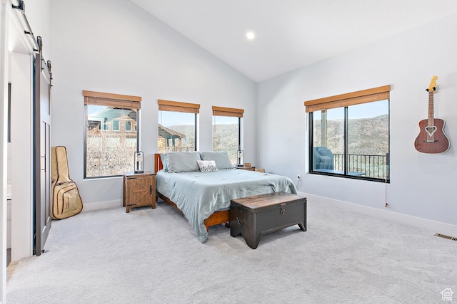 1678 S Ridgeline Dr Unit 1276, Heber City, UT 84032 - bedroom with a barn door, baseboards, visible vents, light colored carpet, and high vaulted ceiling