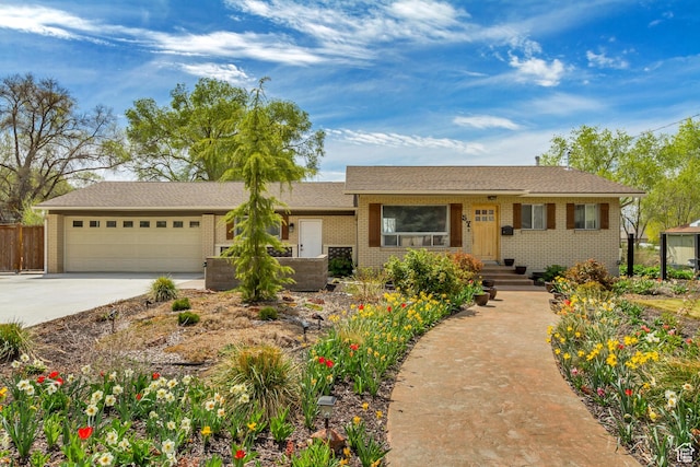 ranch-style house featuring brick siding, an attached garage, and driveway