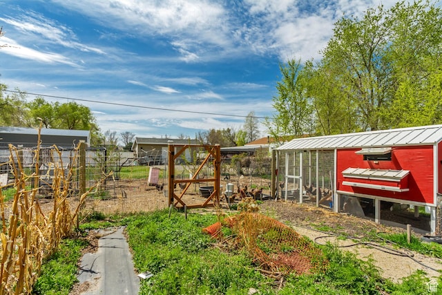 view of yard featuring an outdoor structure and exterior structure