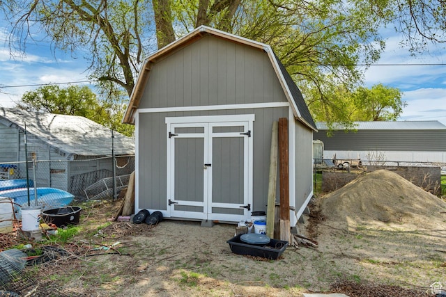 view of shed featuring fence