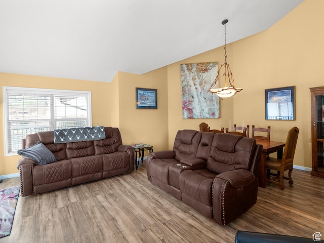 1004 Uri Ln, Midway, UT 84049 - living room featuring vaulted ceiling, baseboards, and wood finished floors