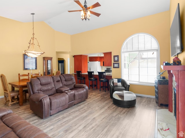 1004 Uri Ln, Midway, UT 84049 - living area featuring high vaulted ceiling, light wood-style flooring, a ceiling fan, and baseboards