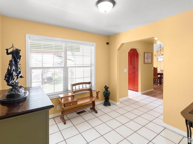 1004 Uri Ln, Midway, UT 84049 - sitting room with light tile patterned floors, arched walkways, a healthy amount of sunlight, and baseboards