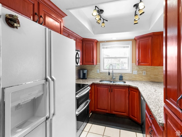 1004 Uri Ln, Midway, UT 84049 - kitchen with a sink, light tile patterned floors, a raised ceiling, backsplash, and appliances with stainless steel finishes