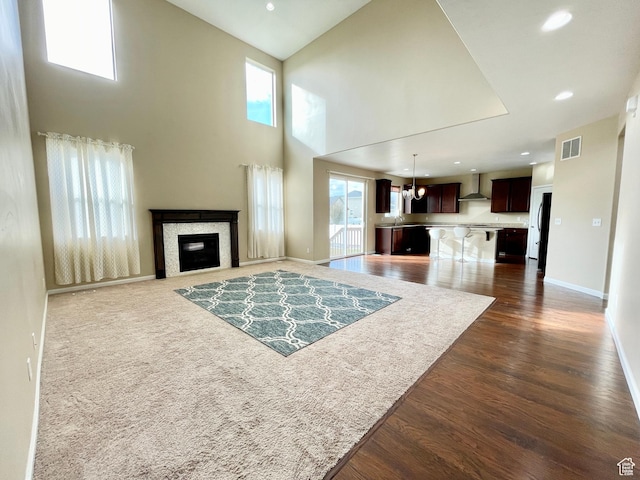 3859 W Young Lucerne Cir, Riverton, UT 84065 - living area featuring recessed lighting, dark wood finished floors, visible vents, baseboards, and a glass covered fireplace