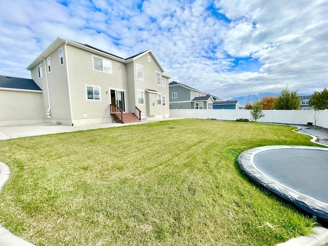 3859 W Young Lucerne Cir, Riverton, UT 84065 - back of property with stucco siding, a lawn, a patio, and fence
