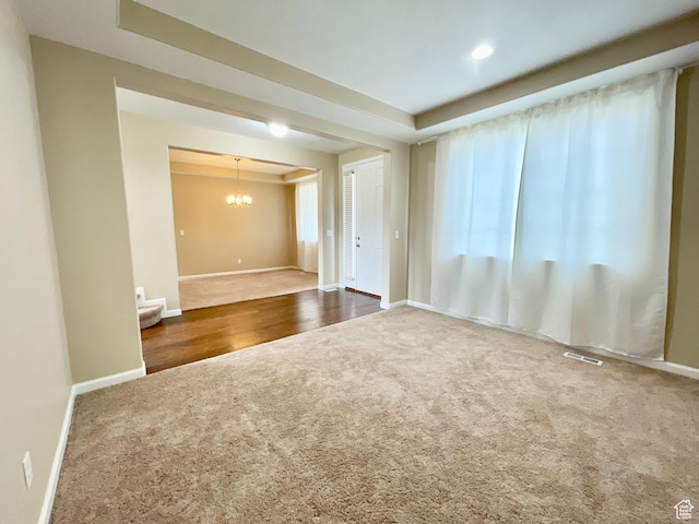 3859 W Young Lucerne Cir, Riverton, UT 84065 - carpeted empty room featuring a raised ceiling, visible vents, baseboards, and an inviting chandelier