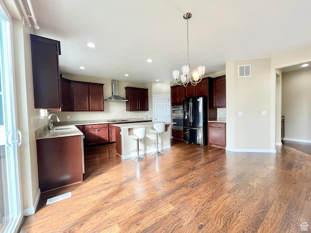3859 W Young Lucerne Cir, Riverton, UT 84065 - kitchen featuring wall chimney exhaust hood, visible vents, dark wood-style floors, and appliances with stainless steel finishes