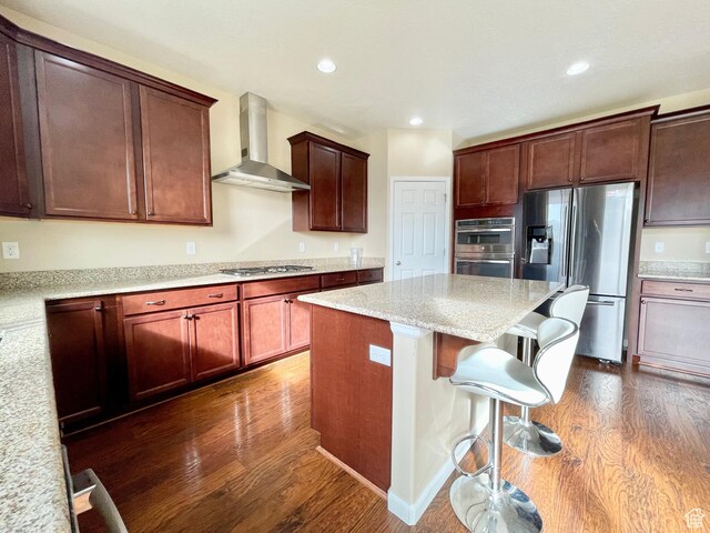 3859 W Young Lucerne Cir, Riverton, UT 84065 - kitchen featuring wall chimney range hood, dark wood-style flooring, appliances with stainless steel finishes, and a kitchen island
