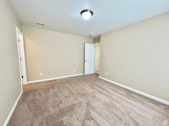 3859 W Young Lucerne Cir, Riverton, UT 84065 - empty room featuring a textured ceiling, visible vents, carpet flooring, and baseboards