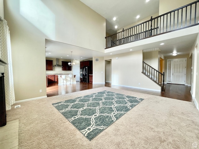 3859 W Young Lucerne Cir, Riverton, UT 84065 - living room with stairs, baseboards, a high ceiling, carpet flooring, and recessed lighting