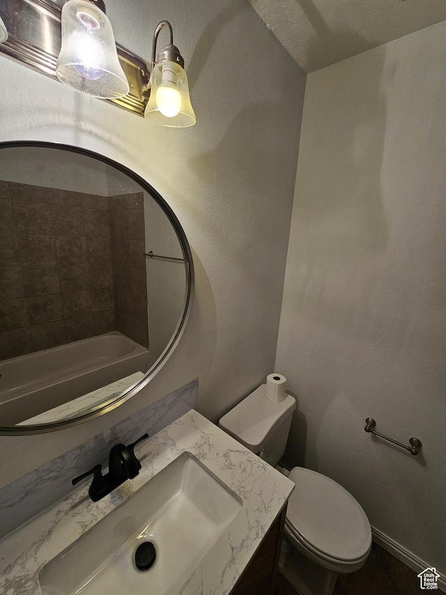 bathroom featuring toilet and vanity