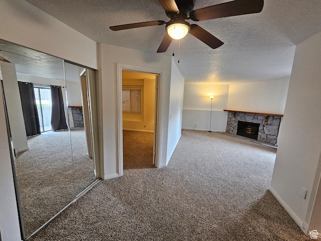 unfurnished living room featuring a textured ceiling, carpet flooring, and ceiling fan