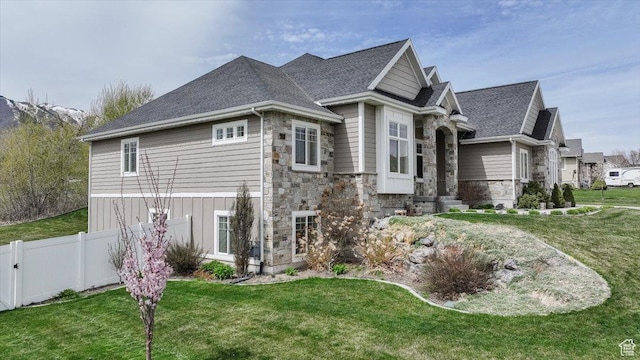 535 N Pheasant Hollow Ln, Mendon, UT 84325 - view of home's exterior featuring stone siding, fence, and a yard