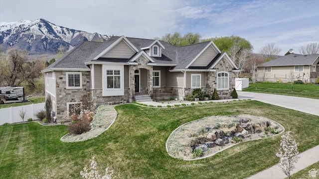 535 N Pheasant Hollow Ln, Mendon, UT 84325 - craftsman-style house featuring a front lawn, fence, and stone siding