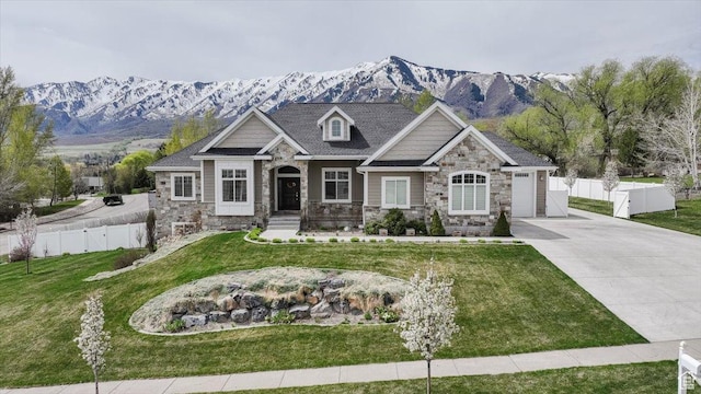 535 N Pheasant Hollow Ln, Mendon, UT 84325 - craftsman inspired home with fence, concrete driveway, stone siding, a front yard, and a mountain view
