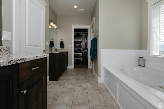 535 N Pheasant Hollow Ln, Mendon, UT 84325 - full bathroom featuring a bath, a spacious closet, and vanity