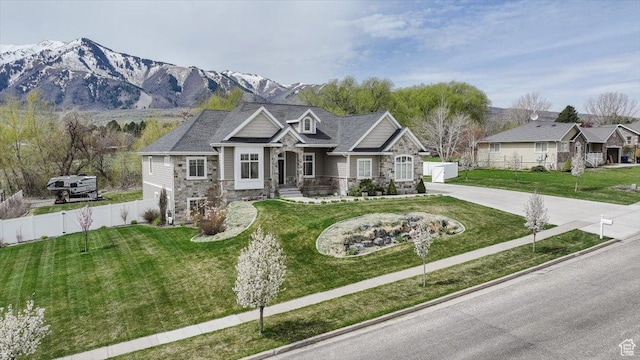 535 N Pheasant Hollow Ln, Mendon, UT 84325 - craftsman-style house featuring concrete driveway, a front lawn, fence, and stone siding