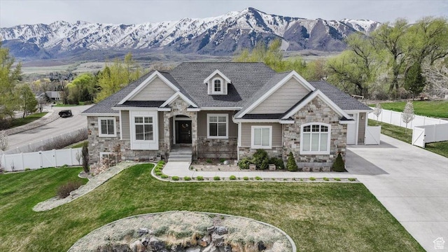 535 N Pheasant Hollow Ln, Mendon, UT 84325 - view of front of house with driveway, stone siding, a front lawn, and a mountain view