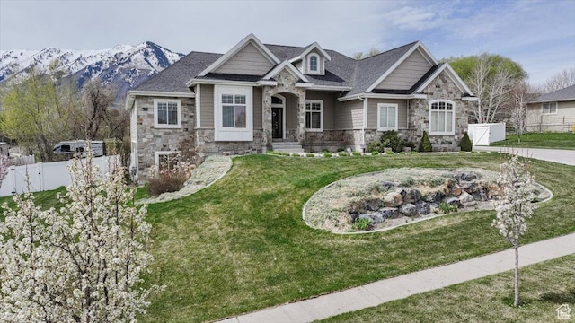 535 N Pheasant Hollow Ln, Mendon, UT 84325 - craftsman-style house featuring a front lawn, fence, and stone siding