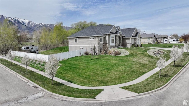 535 N Pheasant Hollow Ln, Mendon, UT 84325 - view of home's exterior featuring fence, a yard, stone siding, and a residential view