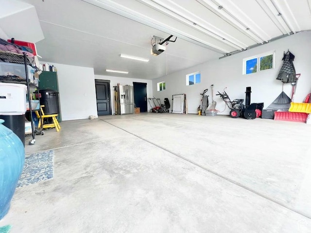 174 S 200 E, Pine Valley, UT 84781 - garage featuring a garage door opener and stainless steel fridge with ice dispenser