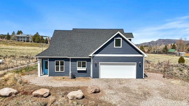 view of front of house featuring a shingled roof and a mountain view
