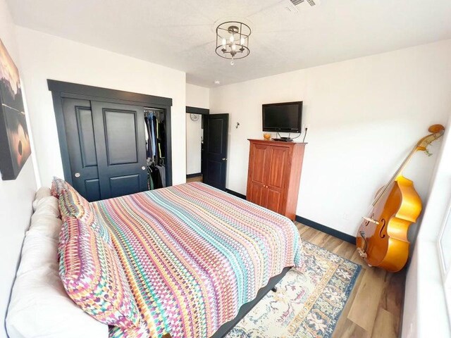 174 S 200 E, Pine Valley, UT 84781 - bedroom with an inviting chandelier, wood finished floors, visible vents, a closet, and baseboards