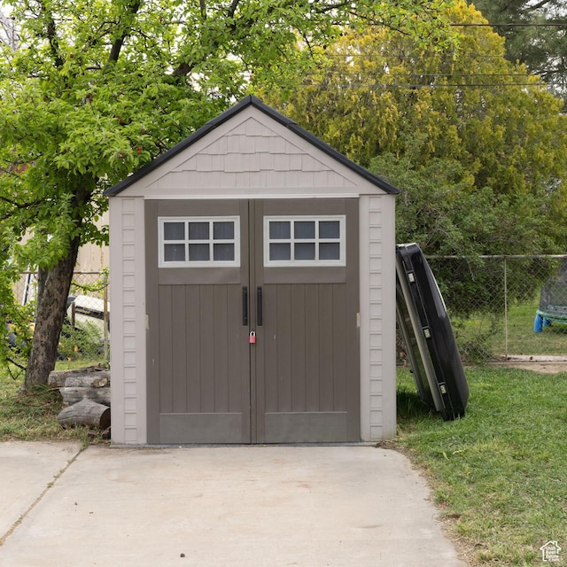 view of shed with fence