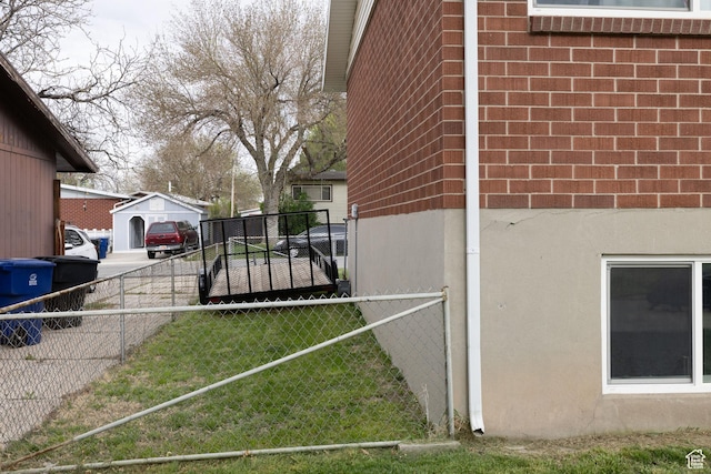view of home's exterior with brick siding, fence, and stucco siding