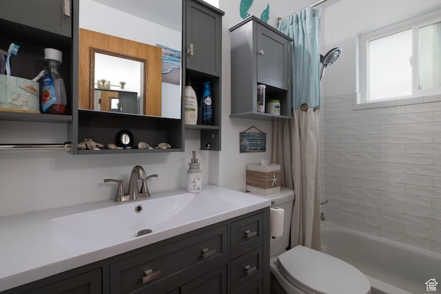 bathroom featuring shower / bath combo with shower curtain, vanity, and toilet