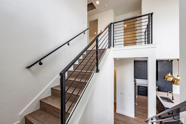 495 W Ascent Dr, Hideout, UT 84036 - staircase with wood finished floors, a high ceiling, and baseboards
