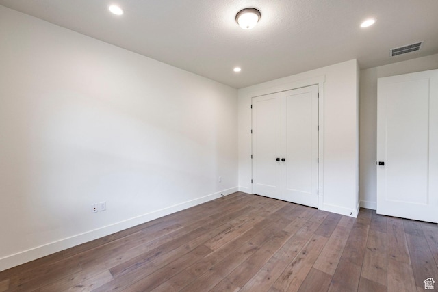 495 W Ascent Dr, Hideout, UT 84036 - unfurnished bedroom featuring baseboards, hardwood / wood-style floors, and visible vents