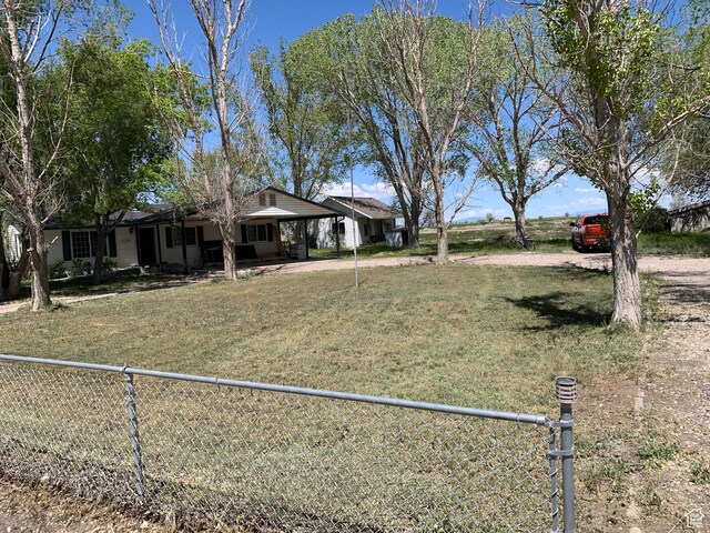 view of front facade featuring fence private yard and a front yard
