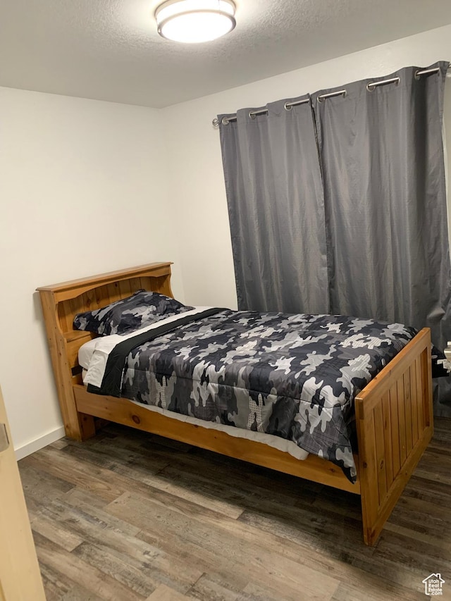 bedroom with wood finished floors