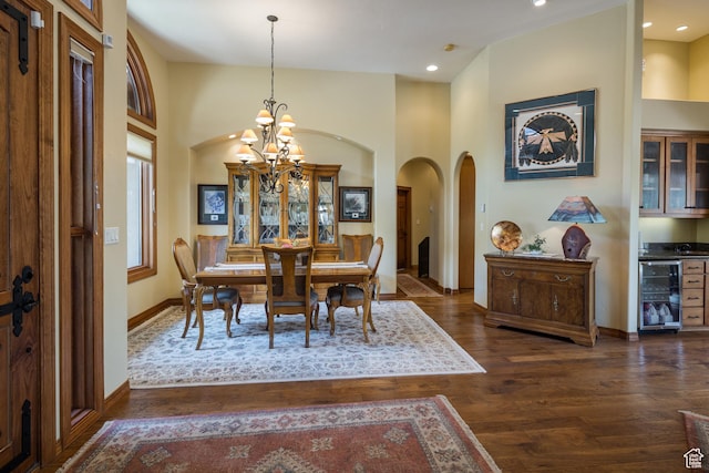 3270 E Rim Vistas Cir, Moab, UT 84532 - dining room featuring arched walkways, dark wood finished floors, baseboards, an inviting chandelier, and beverage cooler