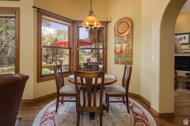 3270 E Rim Vistas Cir, Moab, UT 84532 - dining space with arched walkways, wood finished floors, and baseboards