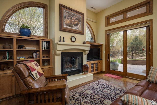 3270 E Rim Vistas Cir, Moab, UT 84532 - living room featuring a glass covered fireplace, wood finished floors, and visible vents