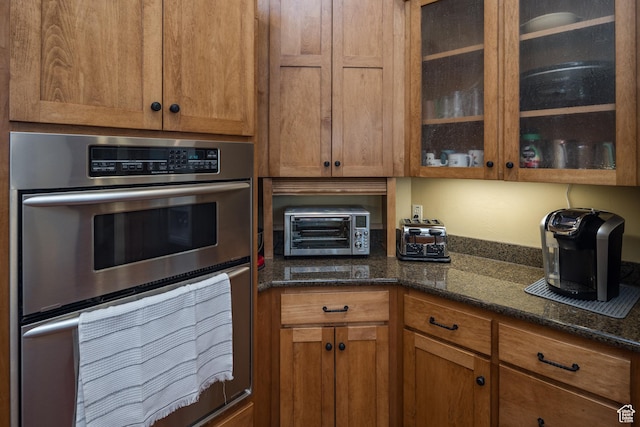 3270 E Rim Vistas Cir, Moab, UT 84532 - kitchen featuring double oven, glass insert cabinets, a toaster, and brown cabinetry